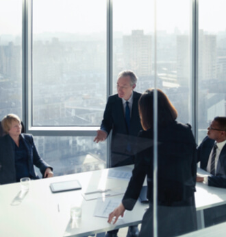 Meeting in modern board room overlooking the skyline